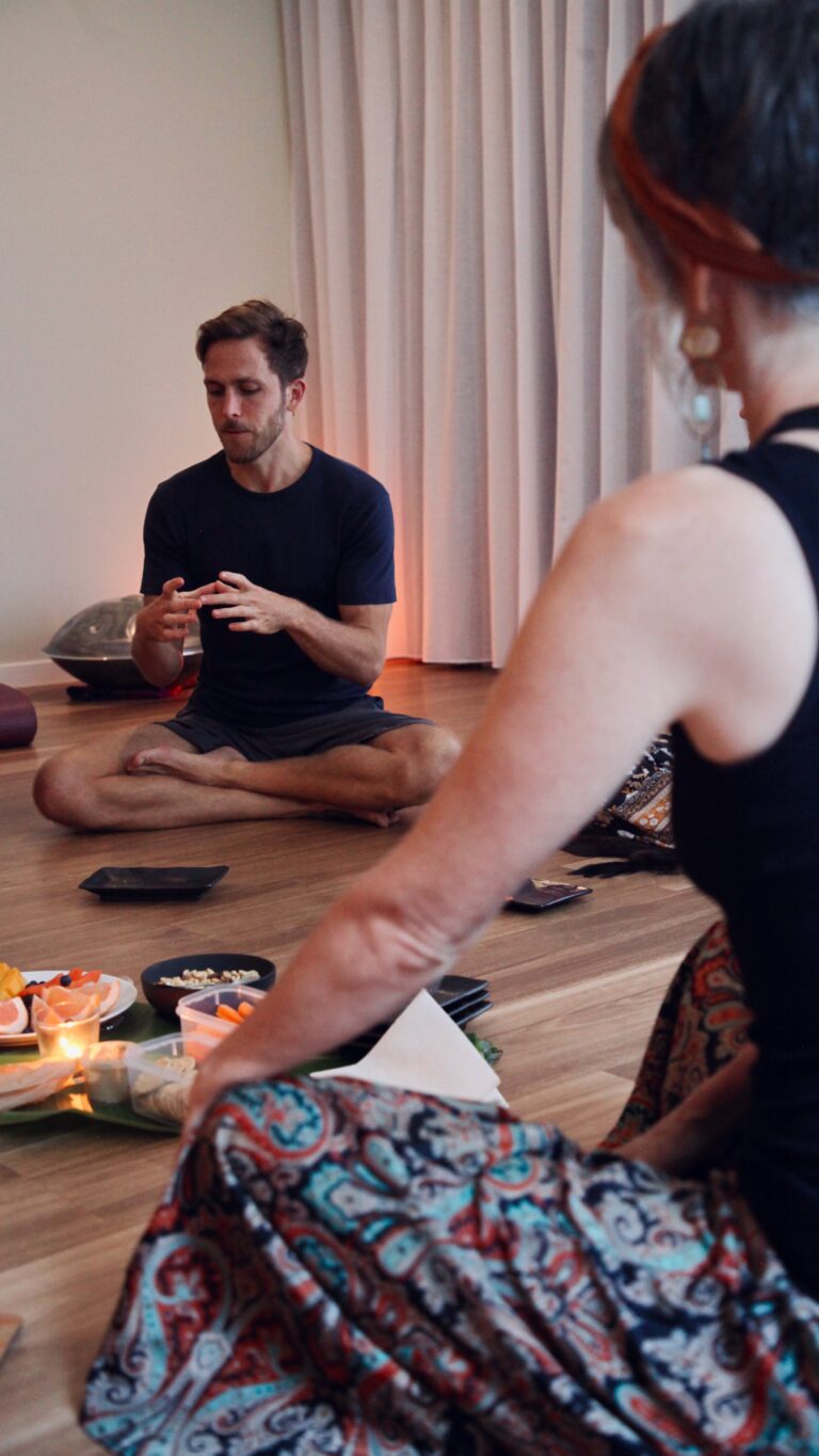 Campbell Will outdoors among trees during a breathwork practice